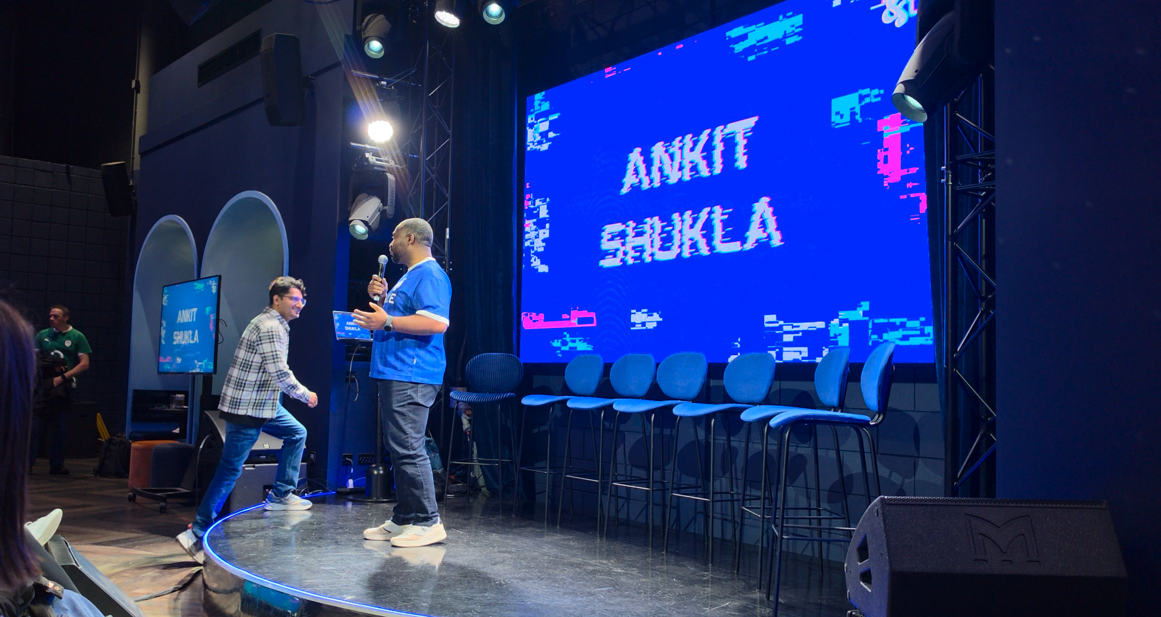 Ankit Shukla walking on stage as his name appears on the screen in London
