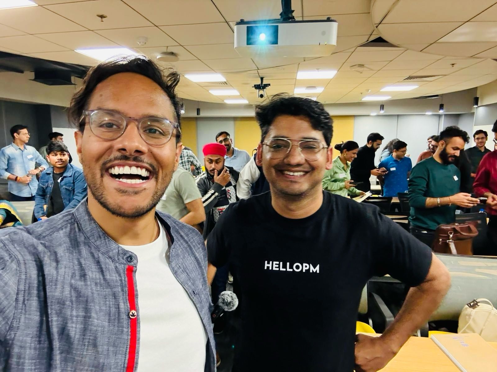 Two HelloPM members smiling for a selfie at an event